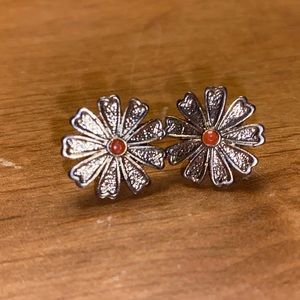 Cute gold earrings with orange in the middle.